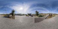 a panoramic view of the city park and a skateboard park in the middle of the day