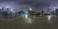 a long exposure photograph of night traffic in the city park with buildings and lights shining