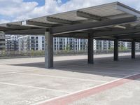 a couple of car parking bays are empty in the sun outside a building in a parking lot