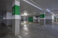 a parking garage is decorated in green and white letters on it's side doors