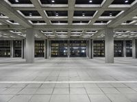 a concrete floor with rows and lots of windows, all of which are lit up