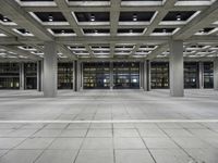 a concrete floor with rows and lots of windows, all of which are lit up