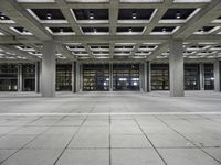 a concrete floor with rows and lots of windows, all of which are lit up