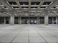 a concrete floor with rows and lots of windows, all of which are lit up