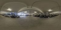 this photo is very 360 - 360 of a large building inside a car park with lots of parked cars