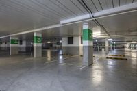 a parking garage is shown with green numbered signs on each side of the spaces for parking