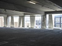 an empty parking garage with several rows of windows and chairs to the left of the door