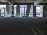 an empty parking garage with several rows of windows and chairs to the left of the door