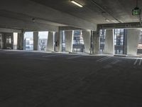 an empty parking garage with several rows of windows and chairs to the left of the door