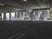 an empty parking garage with several rows of windows and chairs to the left of the door