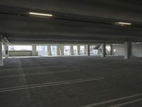 an empty parking garage with several rows of windows and chairs to the left of the door