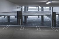 a empty parking garage with the word concrete compact compact written on the floor at the end