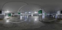 a circle image of cars in a parking garage of some sort with green and white signs