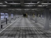 a large empty parking garage with a black and white photo of the interior area, a few chairs and benches