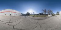 an image of a fisheye lens view of a city parking lot on a clear day