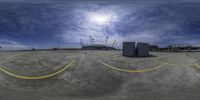 a wide angle shot of the ground and the buildings in the background with a blue sky