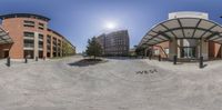 a 360 - view of a parking lot in a city near buildings and trees and the sun shining on the ground