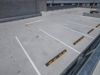 an empty parking lot with a ramp on the floor and stairs behind it in a parking lot