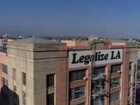 an aerial view of a large building with a large sign that sayslegatize la