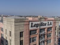 an aerial view of a large building with a large sign that sayslegatize la