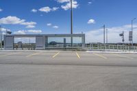 a large parking lot with several parking spaces around it and a sky with some clouds