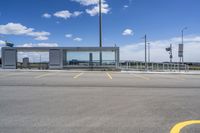 a large parking lot with several parking spaces around it and a sky with some clouds