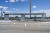 a large parking lot with several parking spaces around it and a sky with some clouds