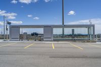 a large parking lot with several parking spaces around it and a sky with some clouds