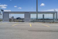 a large parking lot with several parking spaces around it and a sky with some clouds