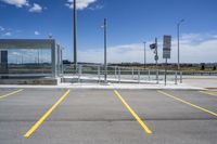 a large parking lot with several parking spaces around it and a sky with some clouds