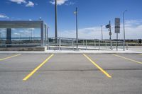 a large parking lot with several parking spaces around it and a sky with some clouds