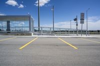 a large parking lot with several parking spaces around it and a sky with some clouds