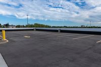 a parking lot with many storage containers under a cloudy blue sky by the docks area