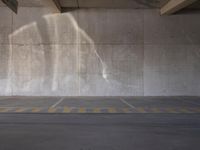 parking spaces with parking permit sign in city parking lot area under bridge - side structure