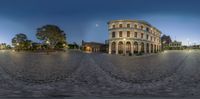 an image of a very large building in the middle of town, that appears to be an open air zone