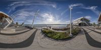 this fish eye view shows the city and its reflection in a panoramic lens