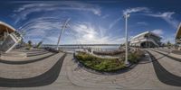 this fish eye view shows the city and its reflection in a panoramic lens