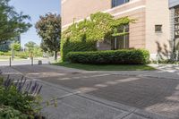 a large brick building sitting next to a lush green tree filled area of grass,