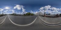 this is a panorama time lapse of a city road in europe with cloudy skies above