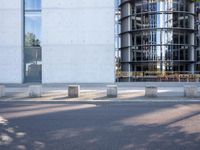 the office building is next to the trees near the sidewalk and walkways with trees