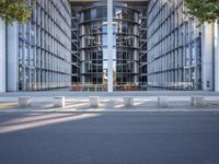 the office building is next to the trees near the sidewalk and walkways with trees