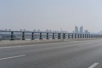 the highway is on its side with the skyline visible in the background as an airplane flies over the highway