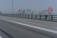 the highway is on its side with the skyline visible in the background as an airplane flies over the highway