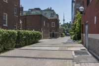 an empty street with brick walls and brick walkwaying down it to the top floor