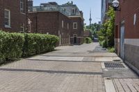 an empty street with brick walls and brick walkwaying down it to the top floor