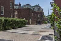 an empty street with brick walls and brick walkwaying down it to the top floor