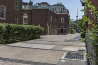 an empty street with brick walls and brick walkwaying down it to the top floor