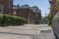 an empty street with brick walls and brick walkwaying down it to the top floor