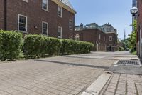 an empty street with brick walls and brick walkwaying down it to the top floor