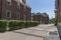 an empty street with brick walls and brick walkwaying down it to the top floor